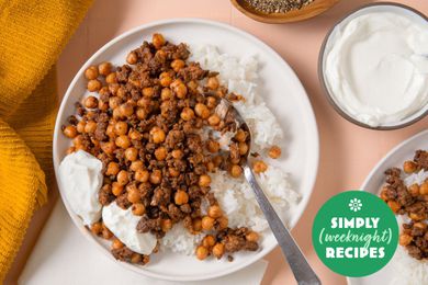 A plate with rice topped with seasoned chickpeas and minced meat, with yogurt on the side, Simply Weeknight Recipes label in view