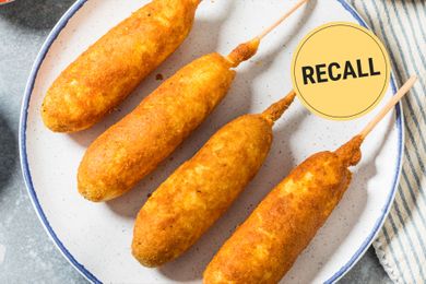 Four corndogs on a plate with a recall notice symbol