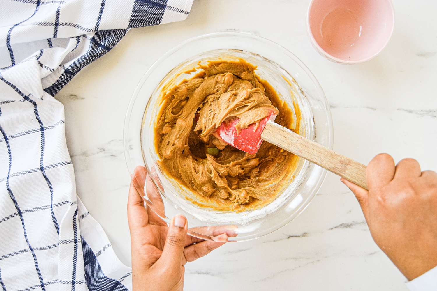 Butterscotch chips being folded into the dough with a spatula