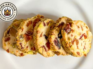 A plate of cookies with nuts and dried fruits King Arthur Baking Company logo visible