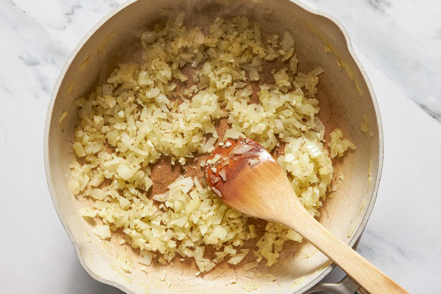 Flour mixed into cooked onions in a pot for chicken cobbler with cheddar bay biscuit top recipe