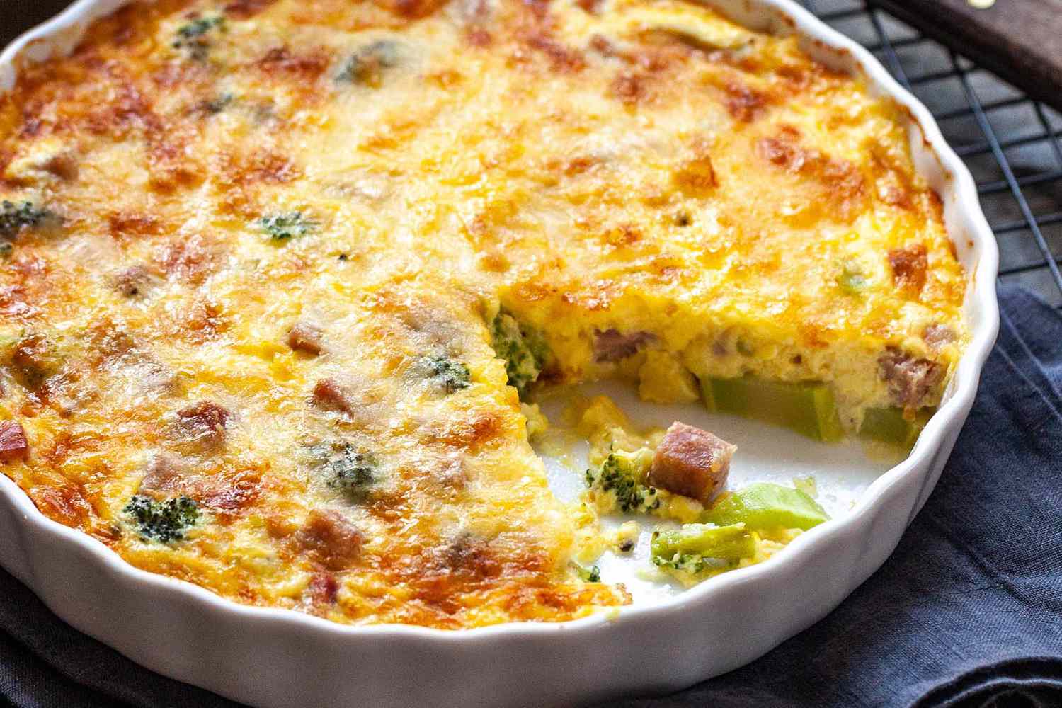 Crustless Quiche with Ham - close up of ham and broccoli quiche in a white dish