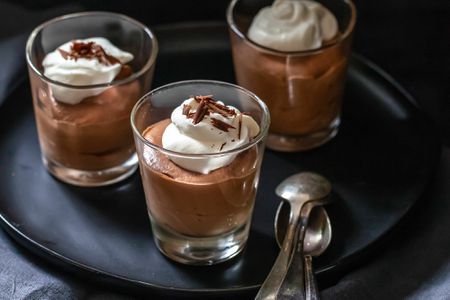 Easy chocolate mousse in serving glasses and set on a tray.