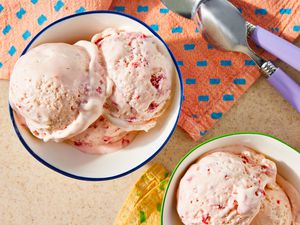 strawberry marlow in two bowls next to table napkins and spoons