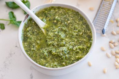 Scallion pesto in white bowl with white spoon