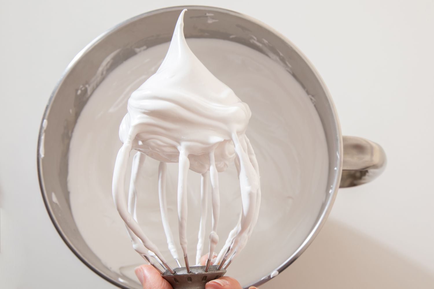 whipped meringue on a stand mixer whisk attachment for berry pavlova recipe