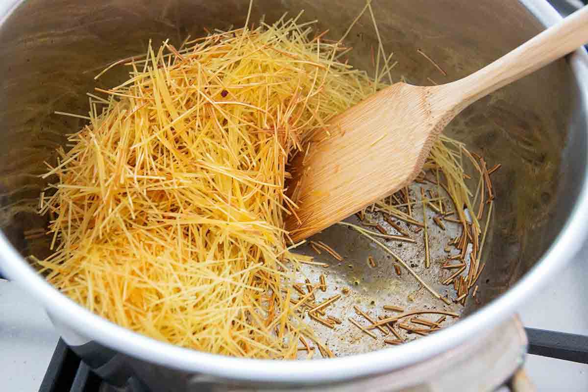 brown the broken noodles in the pot in the chorizo fat