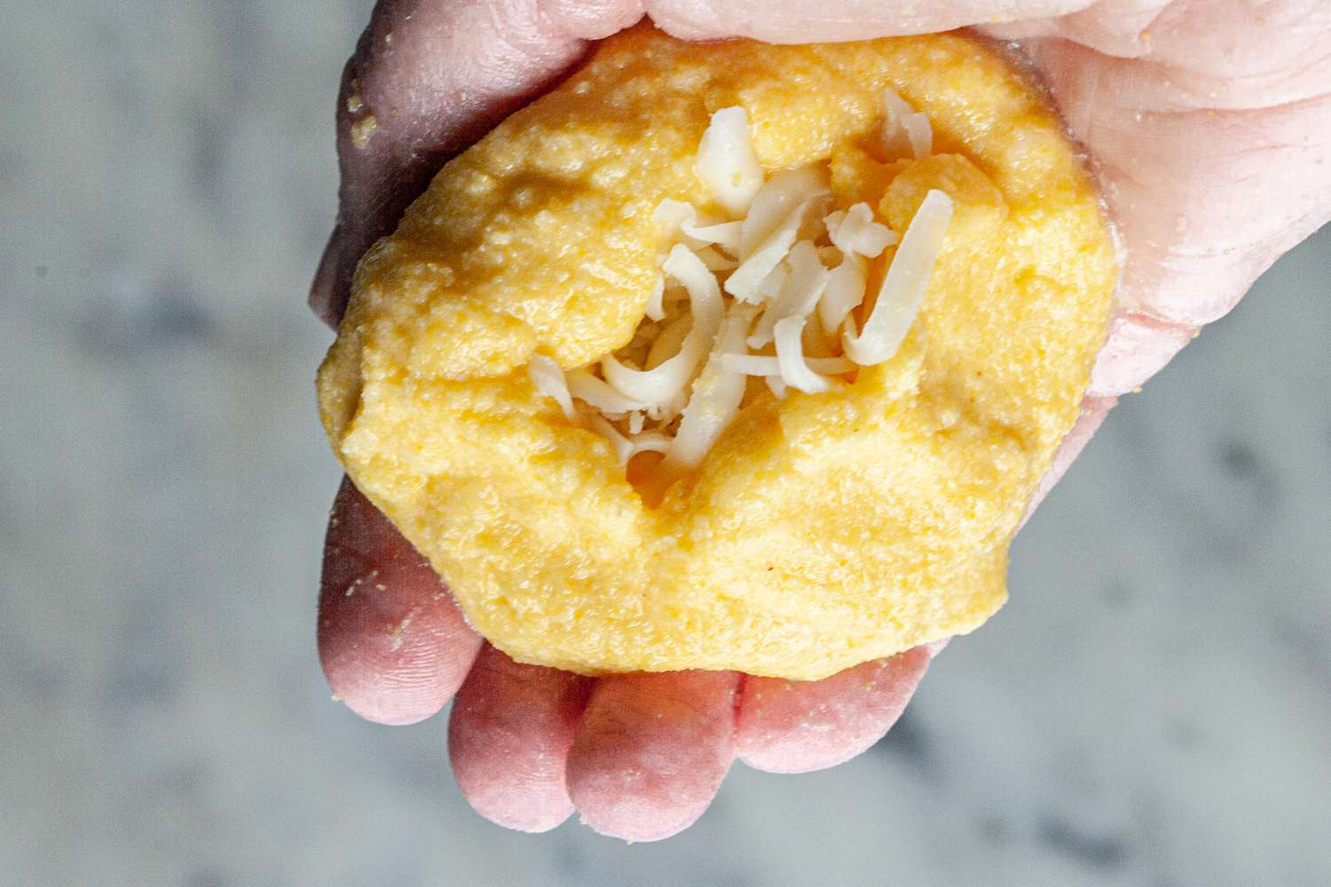 Fill arepa with cheese.