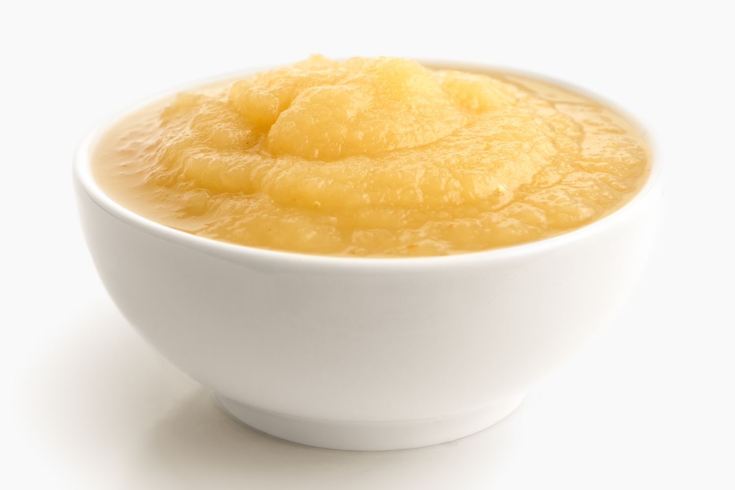 A bowl containing applesauce smooth and creamy texture