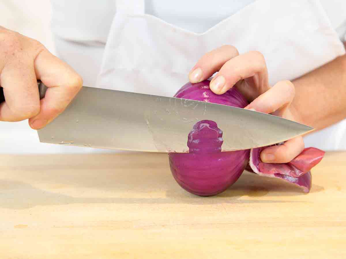 slice a thin sliver from the side of the onion so that when you turn the onion to stand up, it's stable