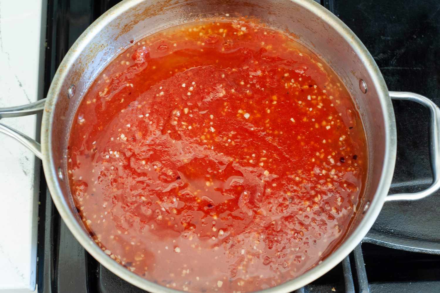 Crushed Tomatoes Added to Skillet for Penne alla Vodka