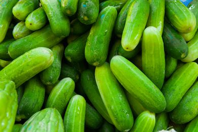 A pile of fresh cucumbers, grouped closely together