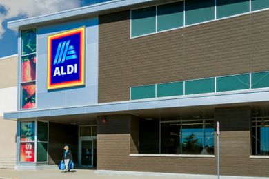 Exterior view of an Aldi supermarket, featuring the store entrance and logo