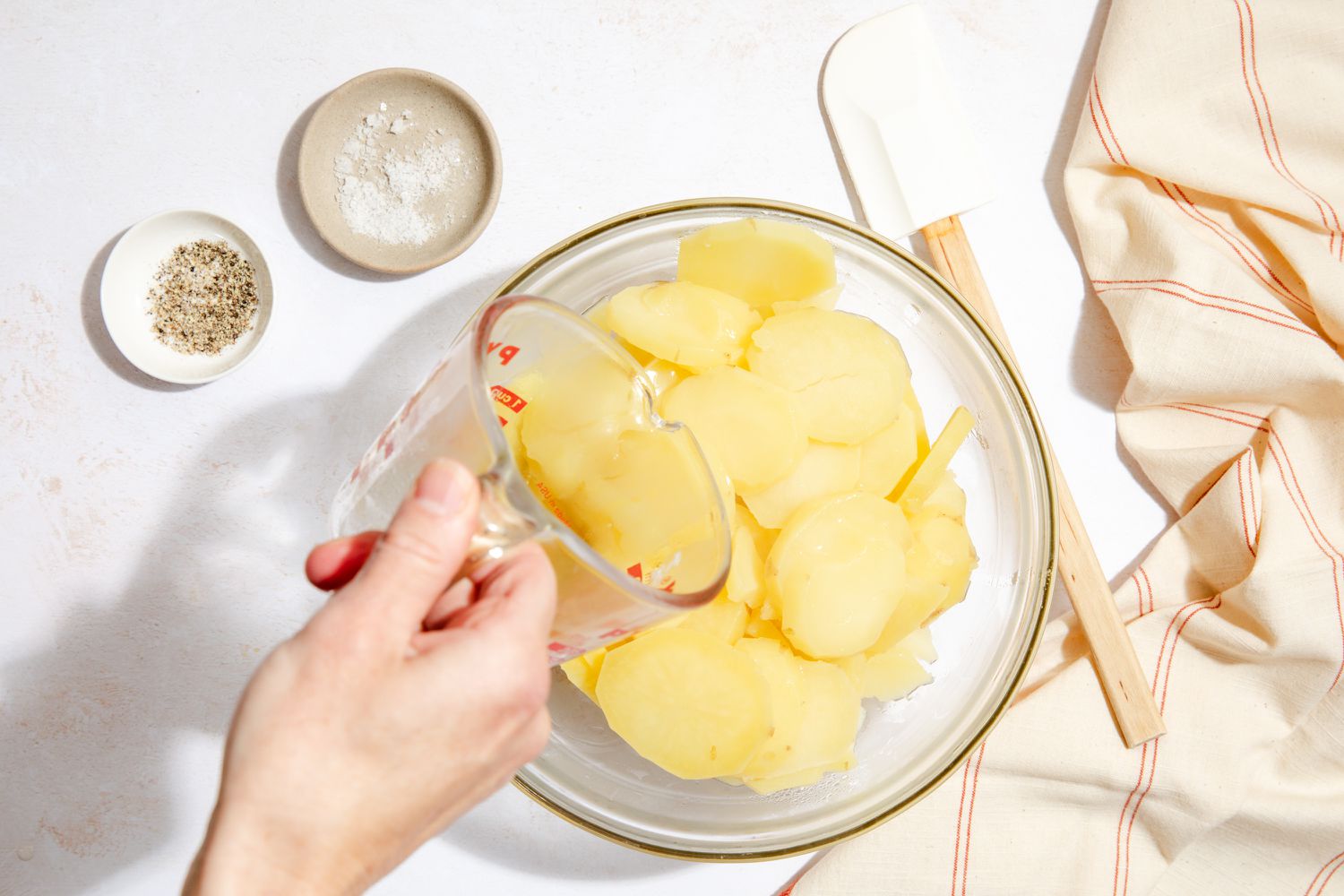 Pour reserved pasta water into cooked potatoes