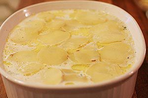creamy scalloped potatoes ready to bake