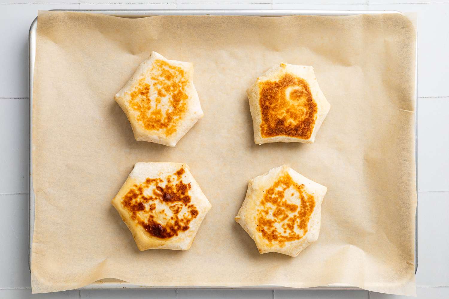 Parchment Paper Lined Baking Tray With Toasted S'mores Crunchwraps