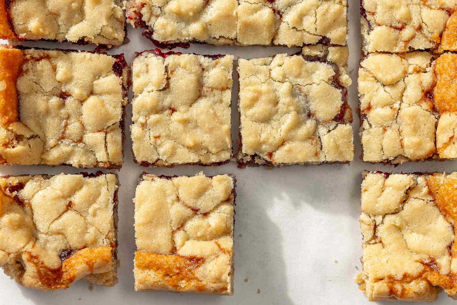 Top view of 2-ingredient jam bar squares on a white surface