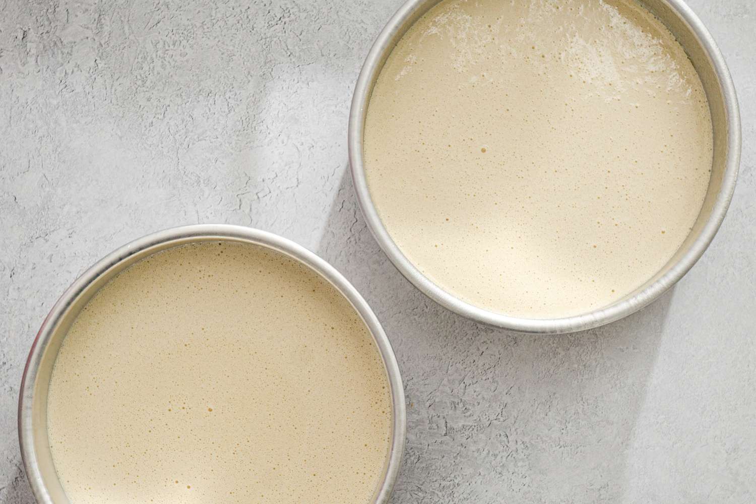 Batter split between two cake pans.