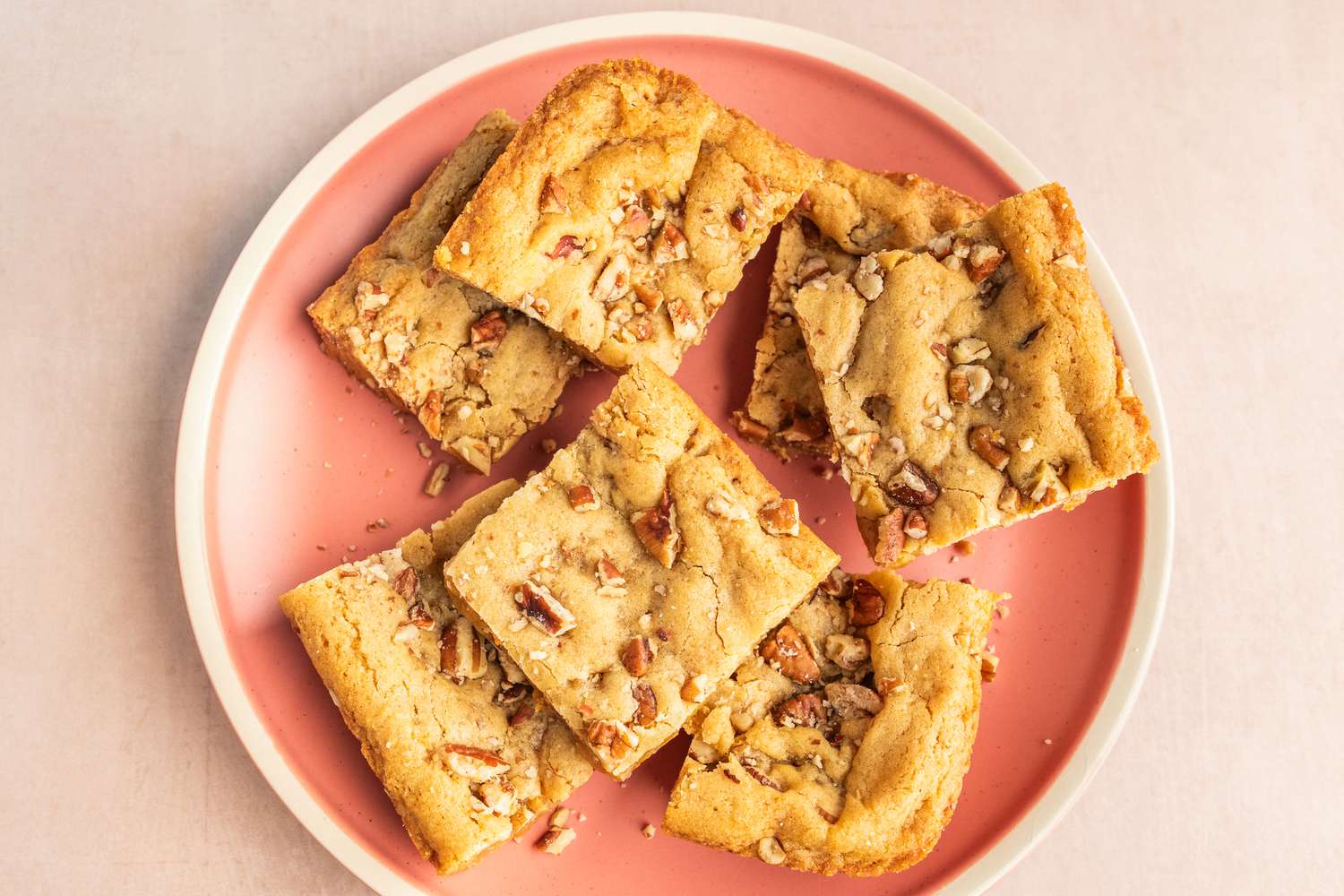 Butterscotch bars on a pink plate