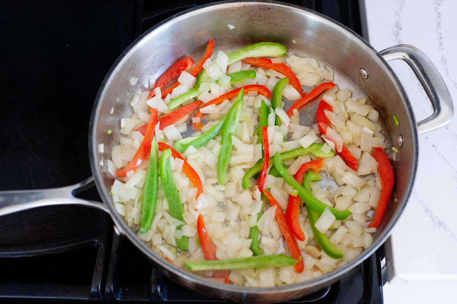 Cooking a black beans and rice recipe in a skillet on the stove.