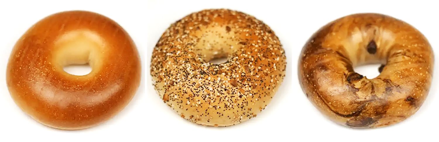 Three bagels arranged side by side plain seeded and swirled variants