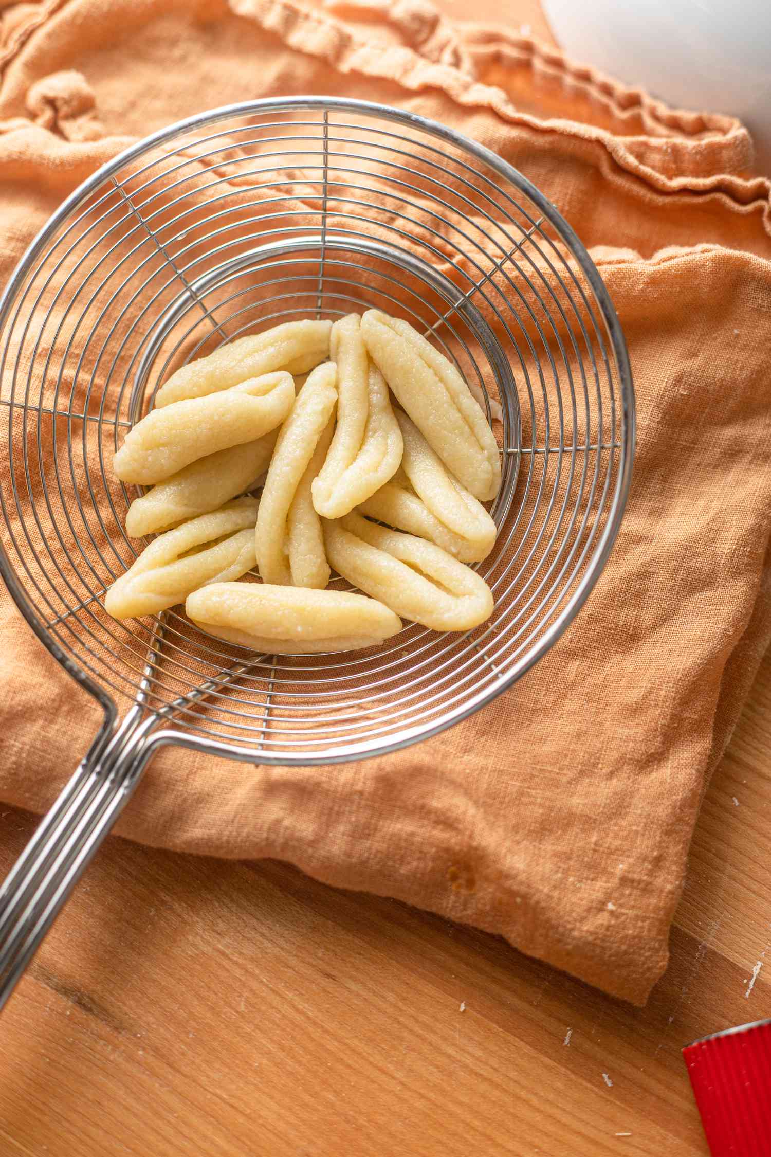 Cooked Cavatelli in a Strainer Rested on a Kitchen Towel 