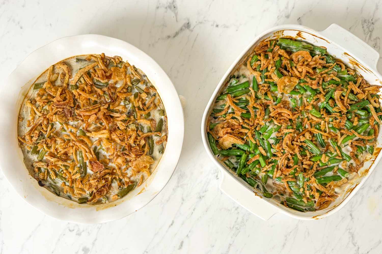 Two green bean casseroles one round and one square topped with crispy onions and ready to serve