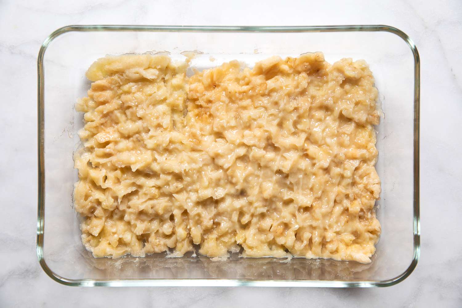 Mashed Banana in a Glass Baking Dish for Banana Ketchup Recipe
