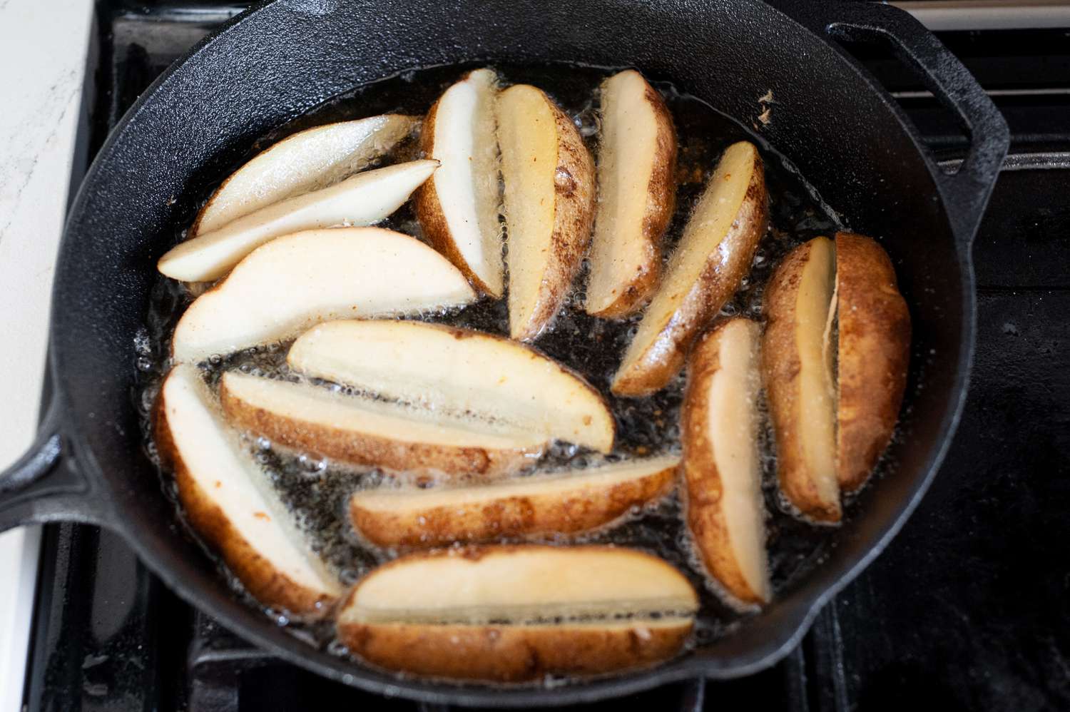 Potato Wedges Fried in Cast Iron Skillet for Chicken Vesuvio