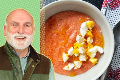 José Andrés alongside a bowl of creamy tomato soup garnished with hard-boiled eggs and spices