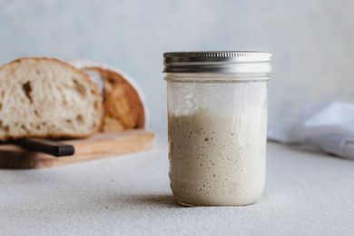 Side view of a mason jar filled with a simple sourdough starter