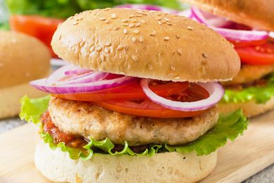 Turkey burger with lettuce, tomato, onion on a sesame seed bun