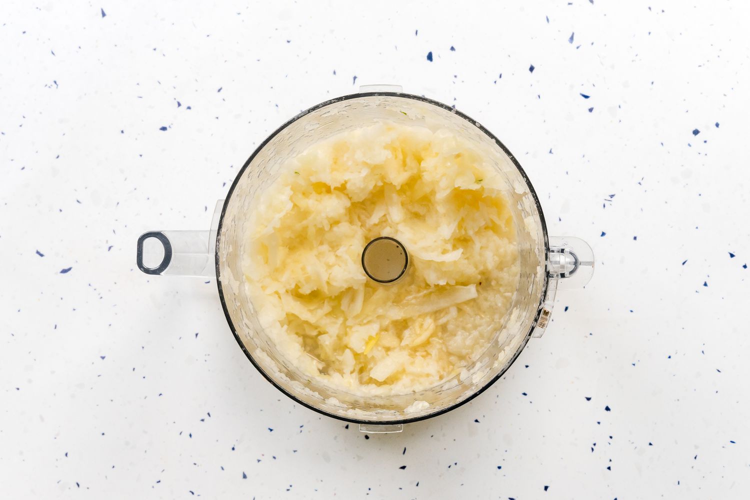 Onions Grated in a Food Processor for Potato Kugel Recipe for Passover 