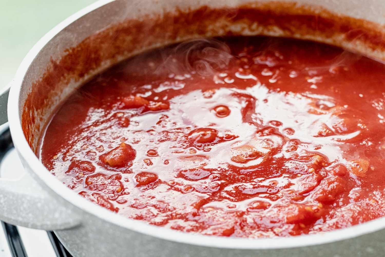 Tomato sauce simmering in a dutch oven