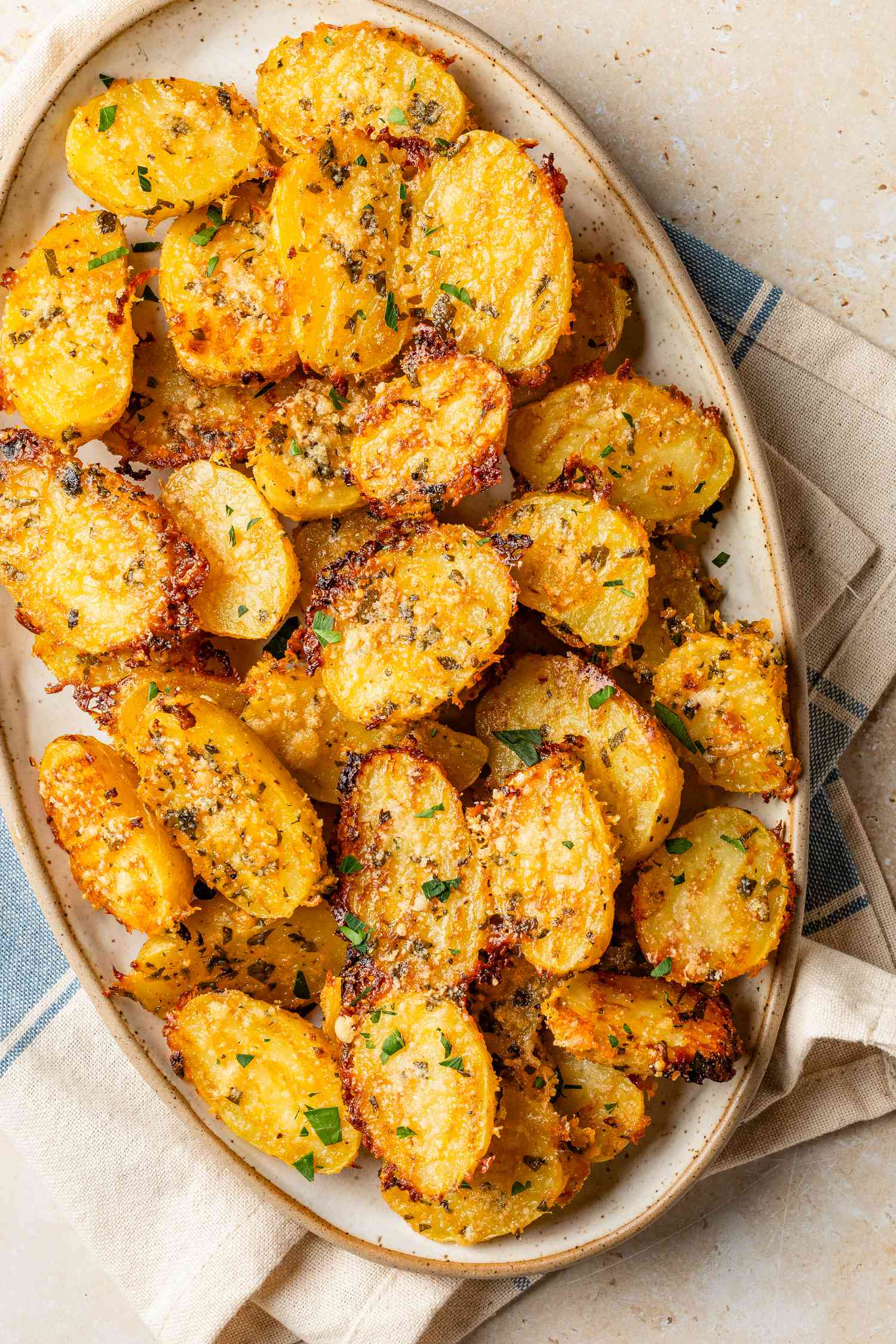 crispy parmesan potatoes on a platter
