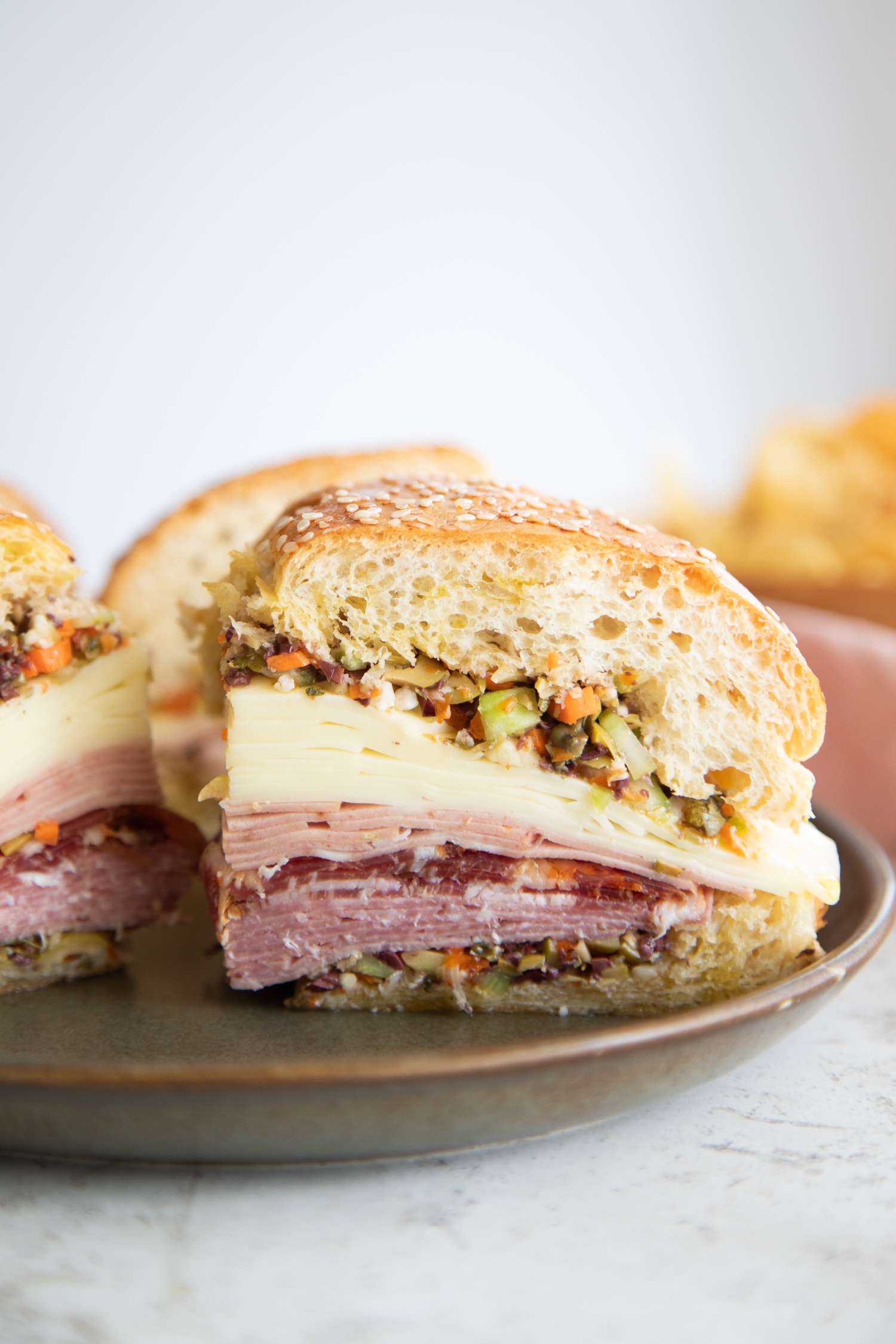 A Classic Muffuletta Sandwich Made with Cold Cuts, Cheese, and Olives
