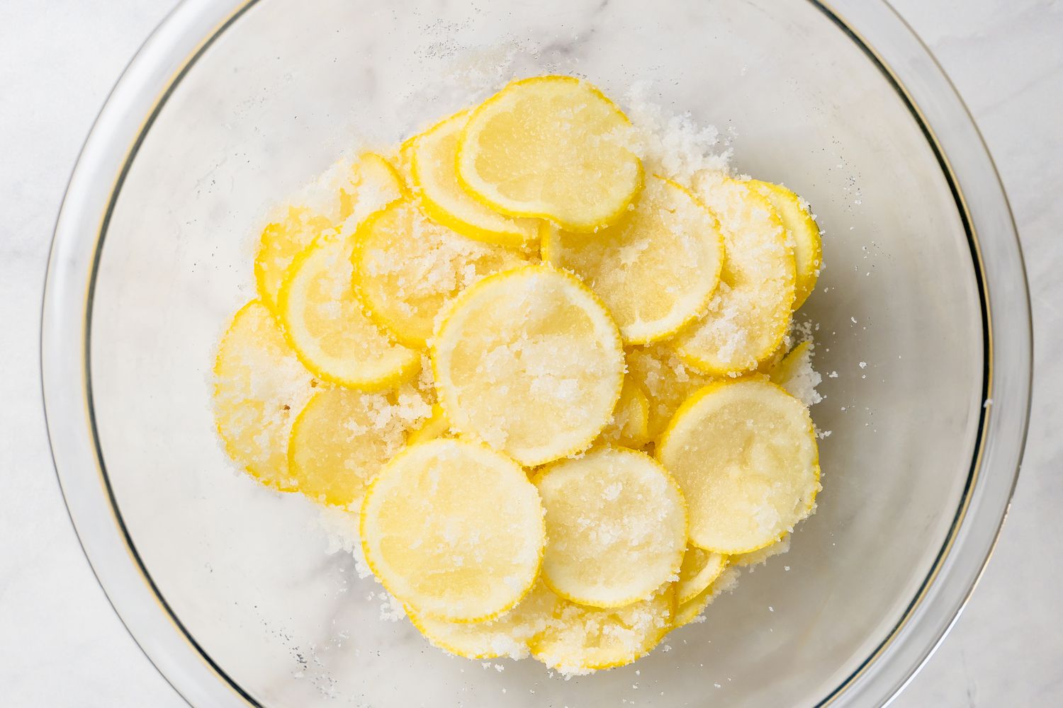 Bowl of Lemon Slices Covered in Sugar for Lemon Bar Recipe