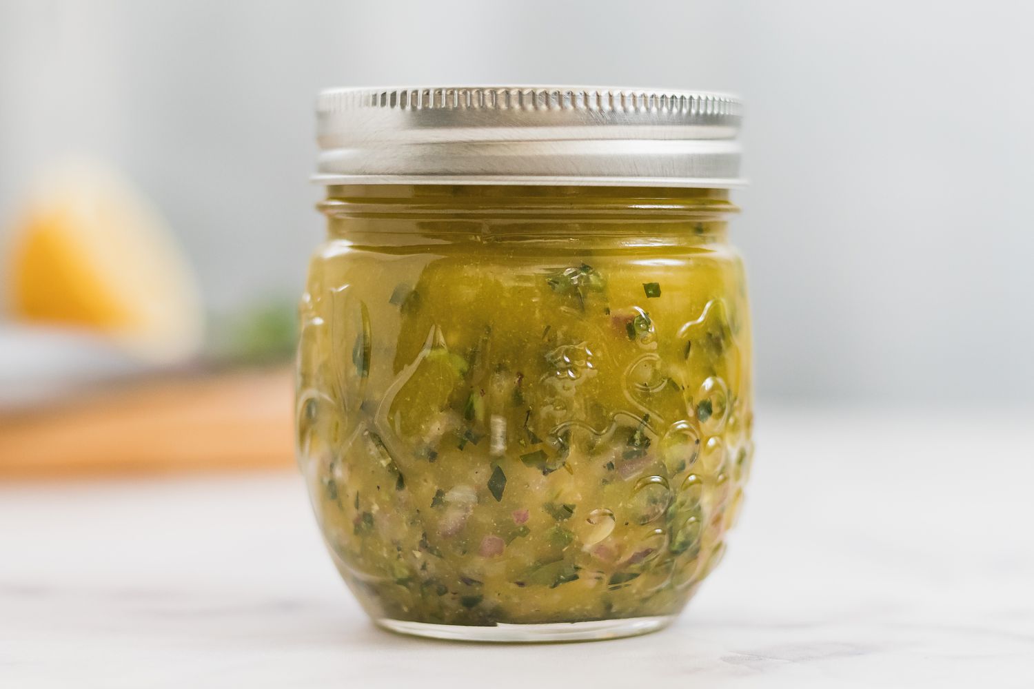 A jar of dressing for tuna nicoise.
