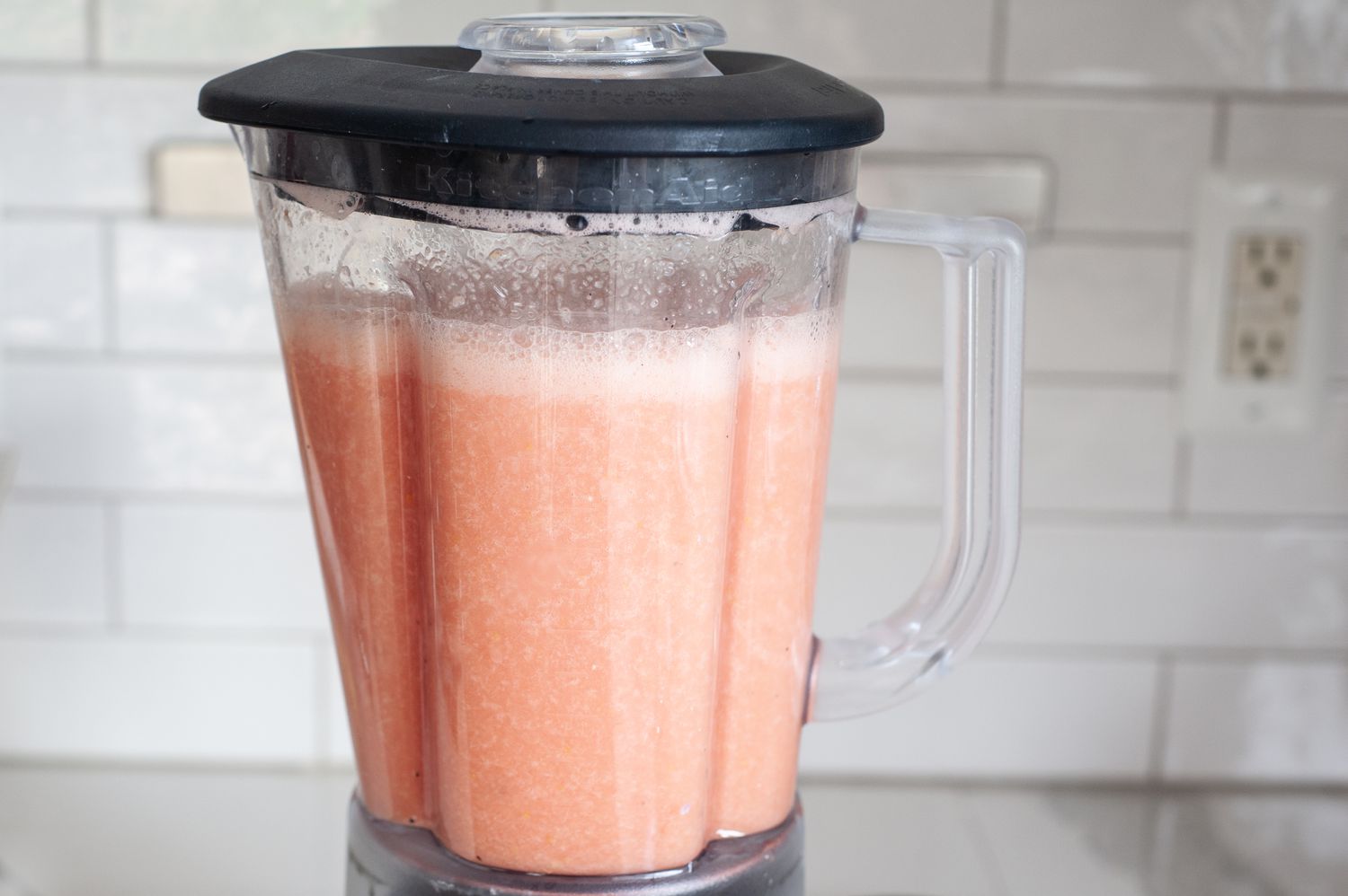 Whole lemon watermelon lemonade in a blender pitcher.