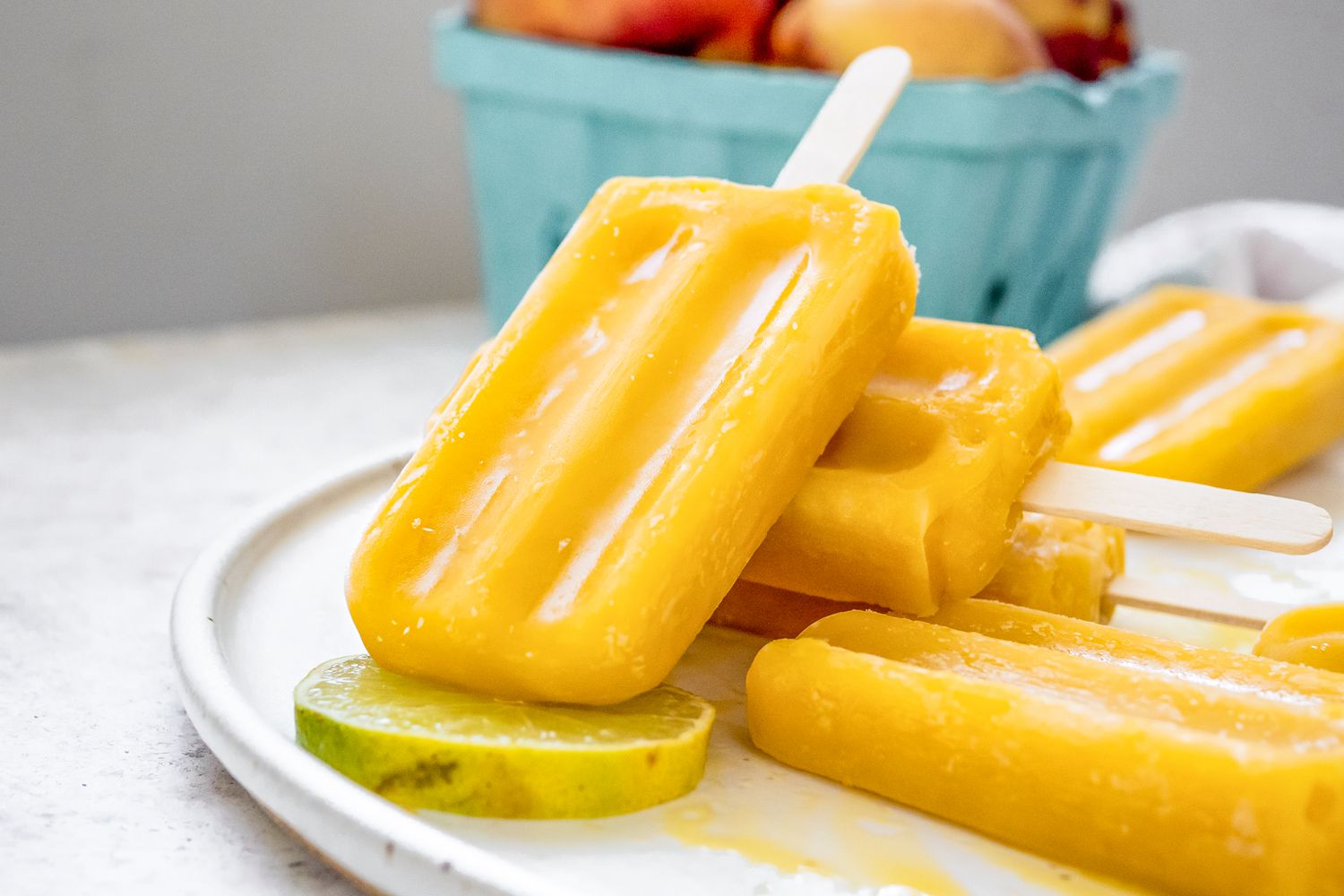 A Plate of Peach Daiquiri Popsicles Slightly Stacked