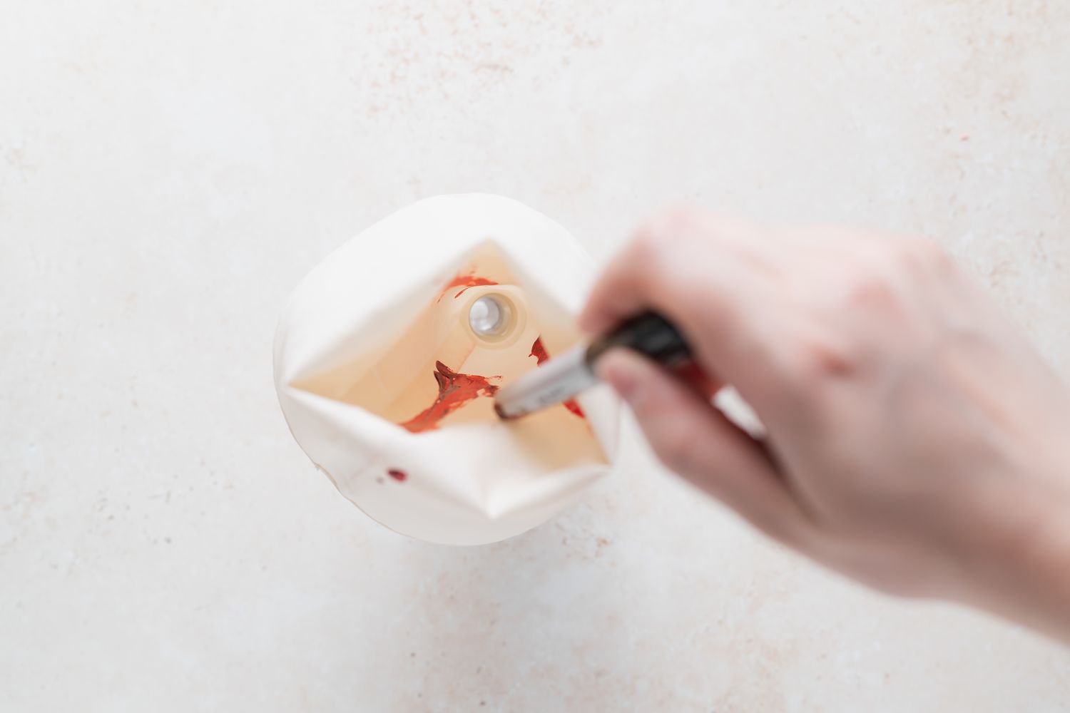 Add food coloring to piping bag for French macarons with peppermint white chocolate filling.