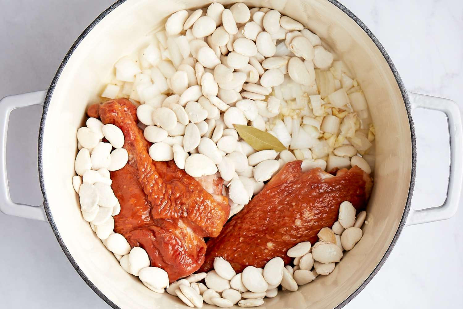Lima Beans, Turkey Wings, Onions, Garlic, and Bay Leaf in Pot for Creamy Lima Beans Recipe