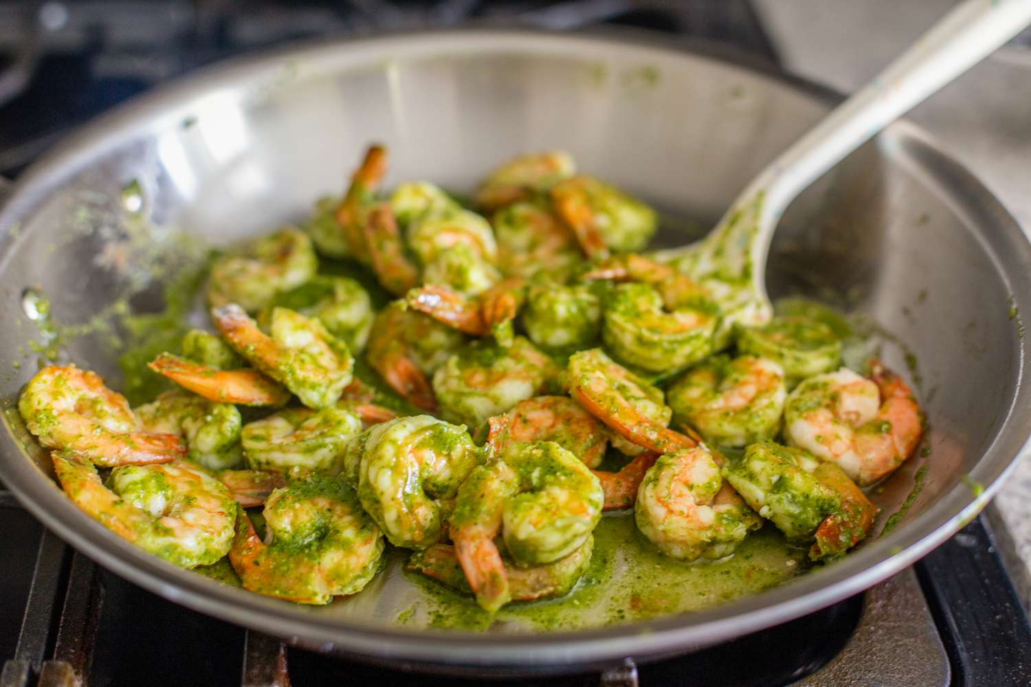 Pesto Shrimp in the Stainless Steel Pan With a Metal Spatula 