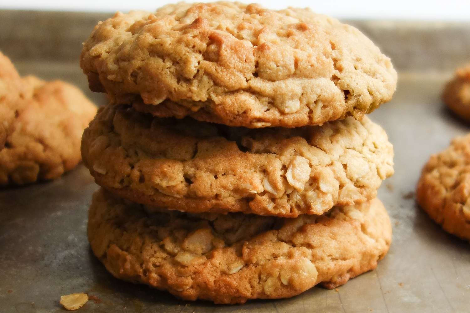 Pile of Chewy Peanut Butter Oatmeal Cookies on a Baking Sheet
