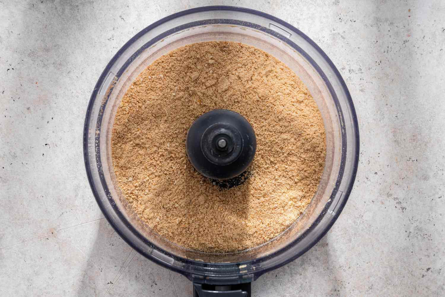 Finely ground graham crackers in a food processor for no-bake pumpkin pie recipe