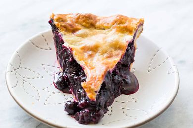 A slice of Blueberry Pie on a white plate