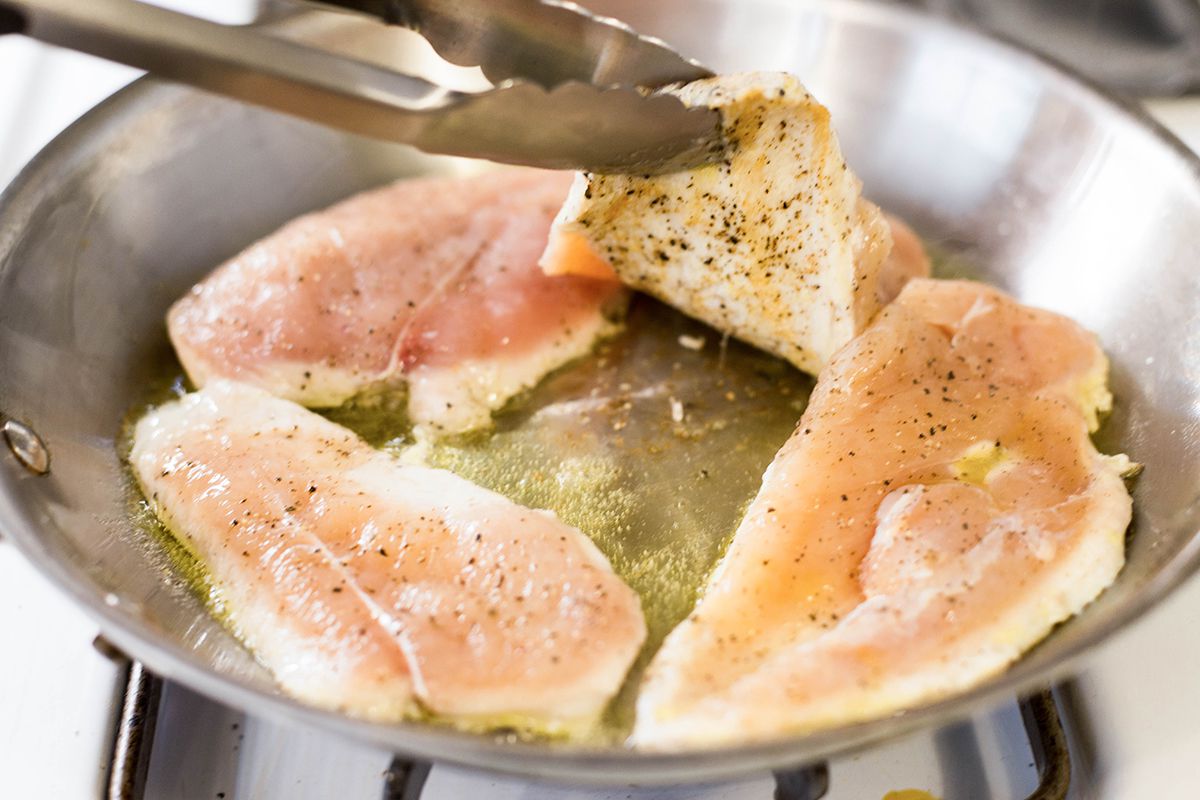 Sear the chicken cutlets in a pan.