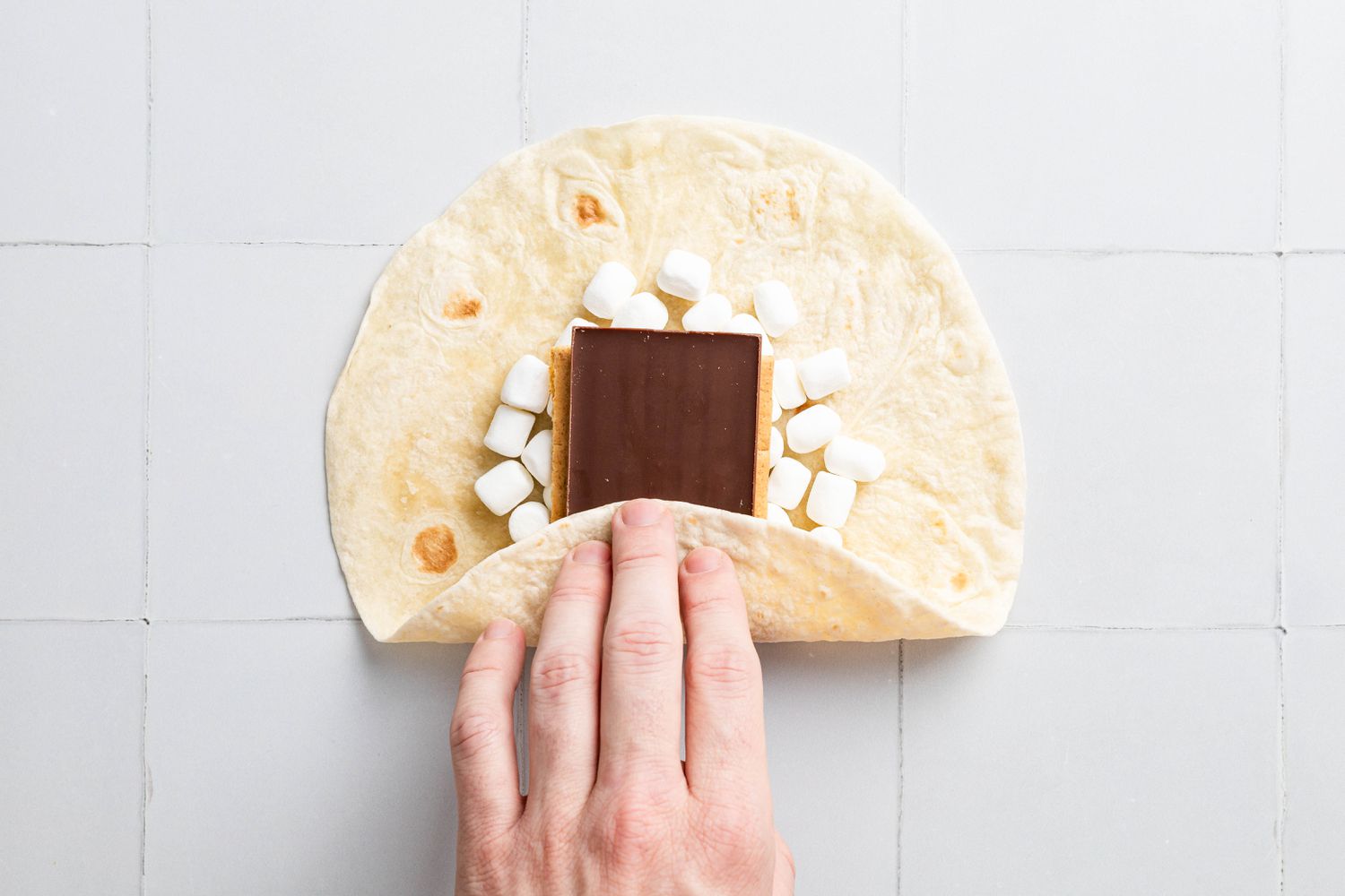 Bottom of Tortilla (Part Closest to the Creator) Folded Over the S'mores Crunchwrap Filling