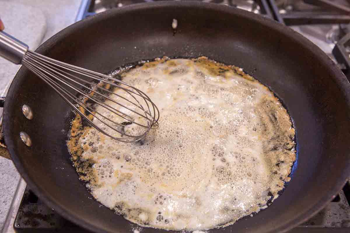 A Swedish meatball sauce being whisked in a pan