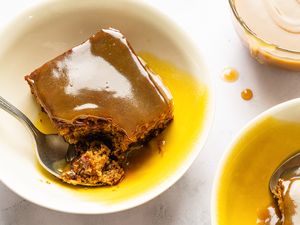 Sticky toffee pudding served in bowls with a spoon